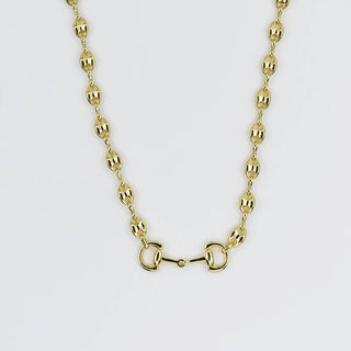 Gold necklace with a horsebit charm