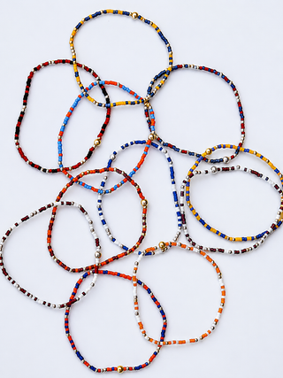 The "Game Day" Enewton beaded bracelets have arrived. The bracelets feature multiple colors including blue, red, orange, yellow, white, and black, with small gold-toned bead accents. Grab your teams color and show your spirit.