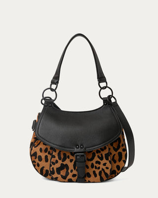 A shoulder bag with a black leather top flap and handle, and a brown and black leopard print lower body.