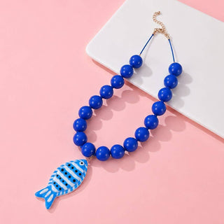 A blue beaded necklace with a fish-shaped pendant.