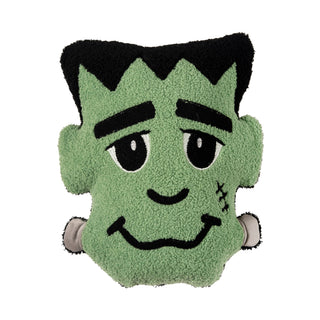 A plush pillow shaped like Frankenstein's monster head, featuring green fuzzy fabric, black hair, and facial details.