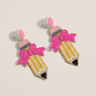 Beaded pencil-shaped earrings with pink tops.