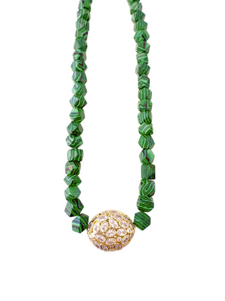 Green beaded necklace with a decorative gold pendant 