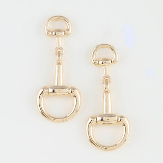 Gold equestrian-style earrings.