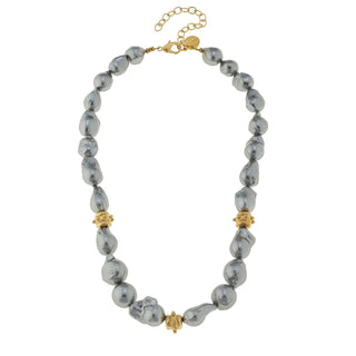 A beaded necklace featuring irregular, baroque-style gray beads with small gold spacer accents and a gold lobster clasp with an extender chain by Susan Shaw.