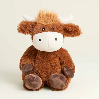 A Warmie Highland cow sitting upright. The toy features brown plush fur, a white snout and horns, and dark brown hooves.