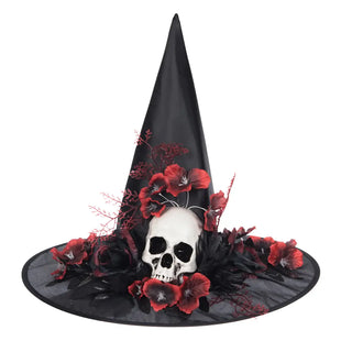 A black witch hat decoration with a wide brim, featuring a white skull at the center, surrounded by red poppy flowers and black feathers on a white background.