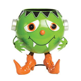 A green Frankenstein-style monster candy bowl with orange boots, white teeth, and silver side details.