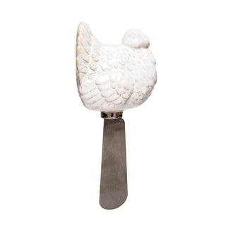 A cheese spreader with a white turkey handle.
