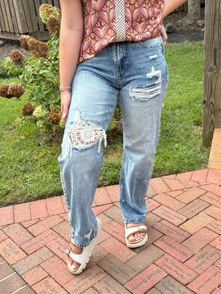 High rise barrel jeans with distressed and crochet details
