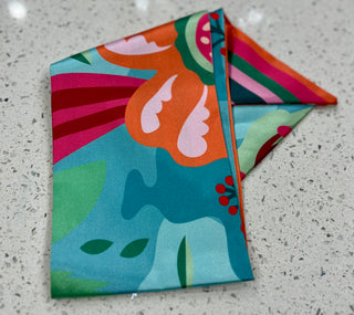 Silky scarf with floral and striped pattern.