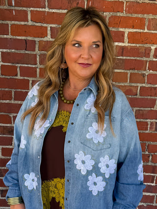 Denim button up shirt with embroidered white and green flowers