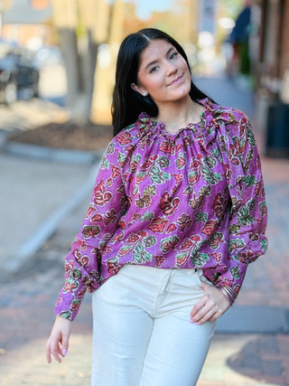 Blouse, featuring a ruffled tie neckline and a red-and-green botanical print against pink