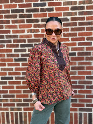 Blouse, featuring a ruffled stand collar, contrast trim, and decorative frog button closure. Lightweight cotton and three-quarter puff sleeves