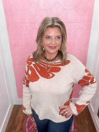 cream and orange floral sweater