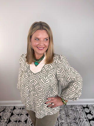 green and cream patterned blouse