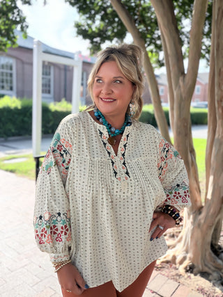 Easel top with floral embroidery across a relaxed dolman-sleeve