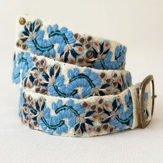 Floral embroidered wool belt with decorative elements.