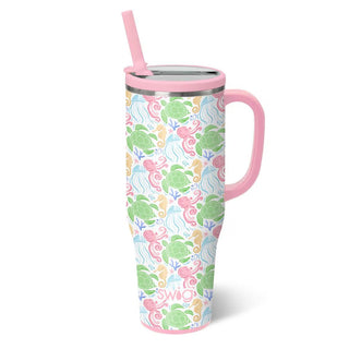 Tumbler with a turtle pattern and pink handle and straw.