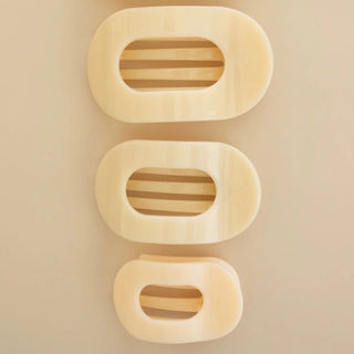 Almond beige flat round hair clips.