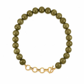 An olive green beaded necklace with a gold-tone toggle clasp.