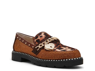A single brown loafer-style shoe with leopard print on the upper, covered in gold rhinestones, a gold chain strap with a heart-shaped padlock, and a chunky black sole.