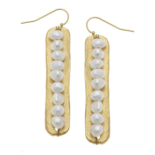 A pair of gold drop earrings featuring textured gold bars with a vertical row of irregular white baroque pearls, suspended from gold fishhook wires by susan shaw.