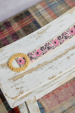 Decorative belt with floral pattern.