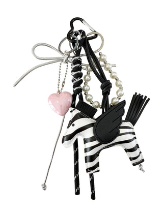 Decorative bag charm with zebra design, heart, and tassel 