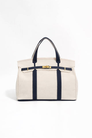 Beige tote bag with navy straps and trim.