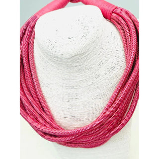 Pink rope strand statement necklace in pale pink.