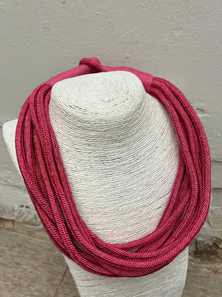 Pink colored rope statement necklace.