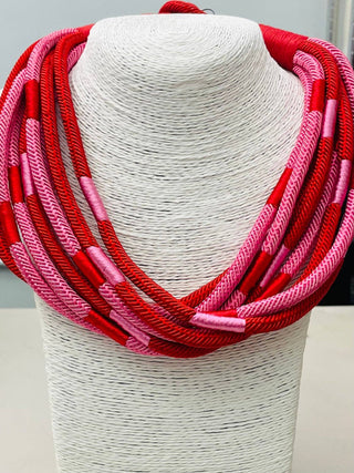Red and pink braided layered rope necklace.