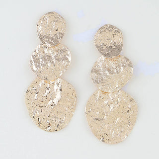 A pair of textured gold disc drop earrings with a stacked three-circle design.