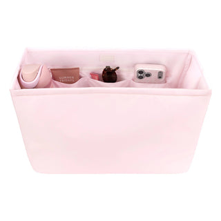 Pink case-mate organizer bag with compartments containing various items.