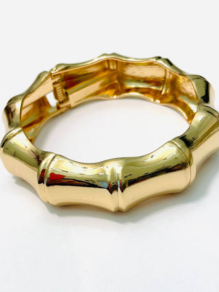 Gold hinged bamboo bracelet.