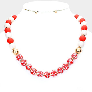 Christmas themed necklace with red, white, and gold beads.