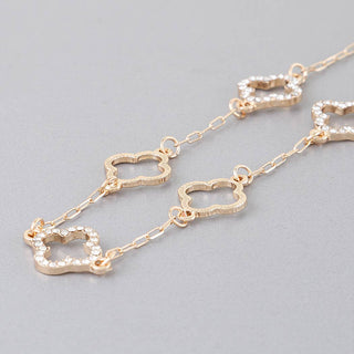 Gold chain necklace with clover-shaped links.