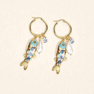 Gold hoop earrings with fish charms.