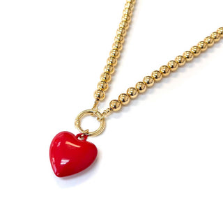Gold necklace with a red heart pendant 