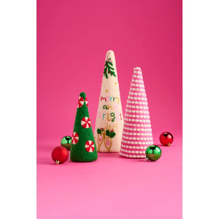 Three handmade felt Christmas tree ornaments in green, cream, and pink patterns, decorated with festive details and surrounded by red and green ornaments on a vibrant pink background.