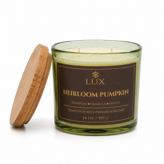 A 14 oz green glass candle jar with a brown label reading 'LUX Heirloom Pumpkin' and a light wood lid. It is  pumpkin and vanilla scented.