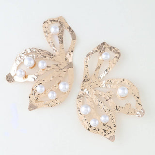 A pair of gold-toned floral-shaped earrings embellished with white faux pearls.