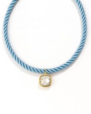 Light blue cord necklace with a clear stone pendant
