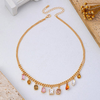 A gold-tone chain necklace with multiple dangling rectangular and teardrop gemstone charms in beautiful earth tone colors of pink, yellow, brown, white, and orange.