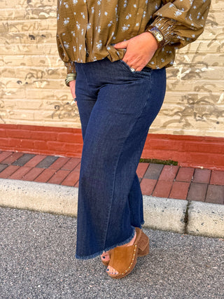 dark denim jeans with elastic waist band and frayed hem