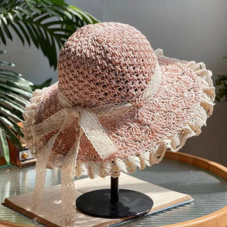 Pink crochet foldable sun hat with a bow. 