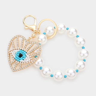 Pearl keychain/bracelet with a heart-shaped evil eye charm.