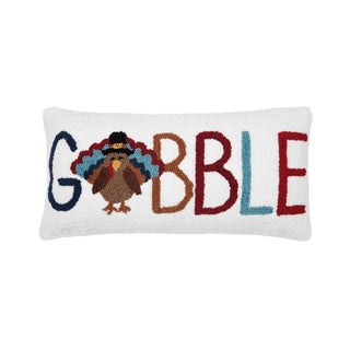Decorative pillow with 'Gobble' text and a turkey design.