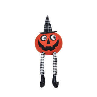 A Halloween-themed plush pumpkin decoration with a carved orange face, black and white patterned witch hat, and long black-and-white patterned legs ending in black shoes.